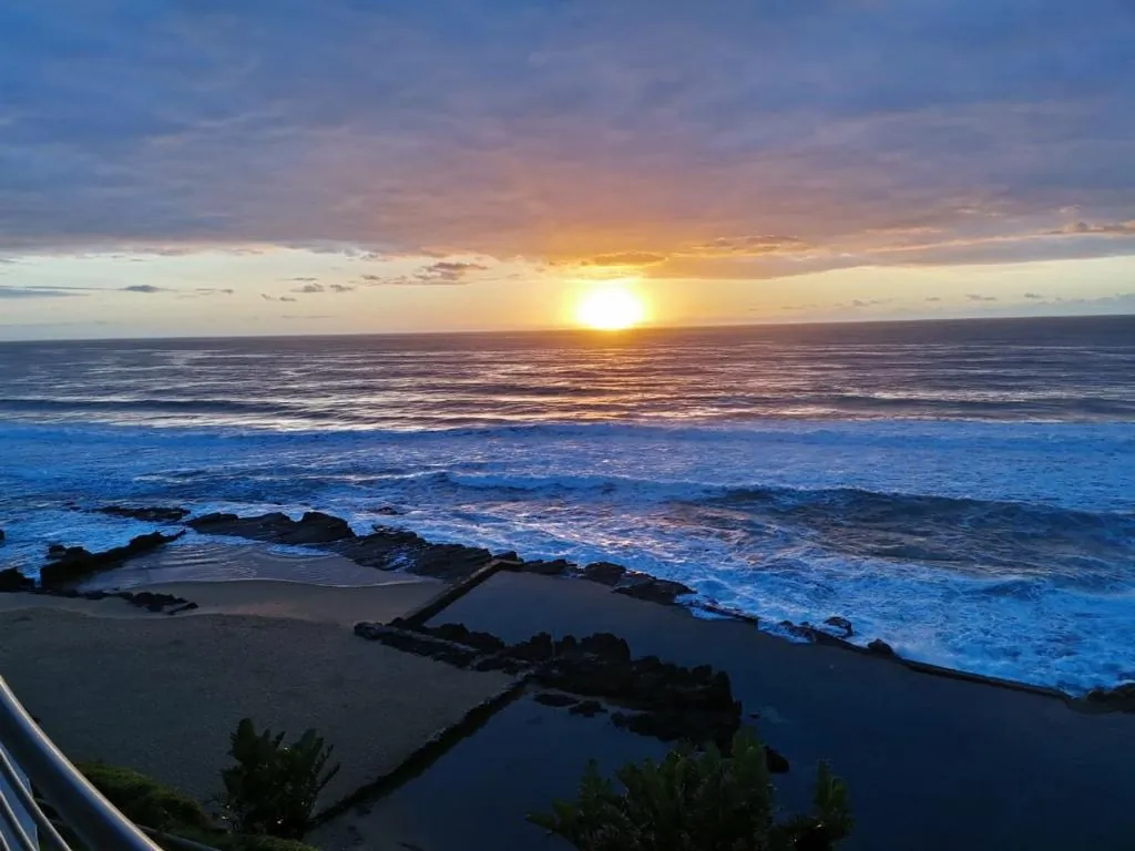Sunset over the ocean and the tidal pool at Chaka's Cove