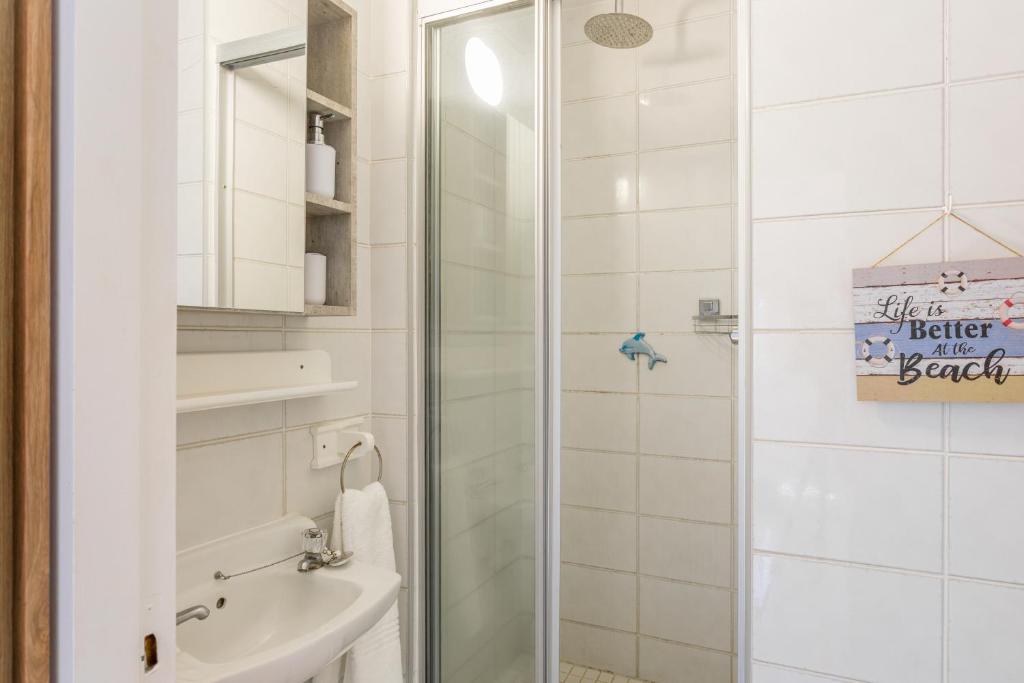 Bathroom with a walk in glass shower at Ocean Blue