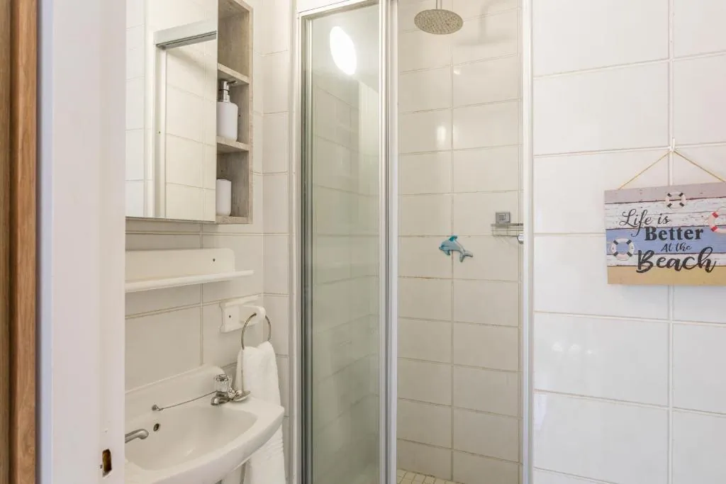 Bathroom with a walk in glass shower at Ocean Blue