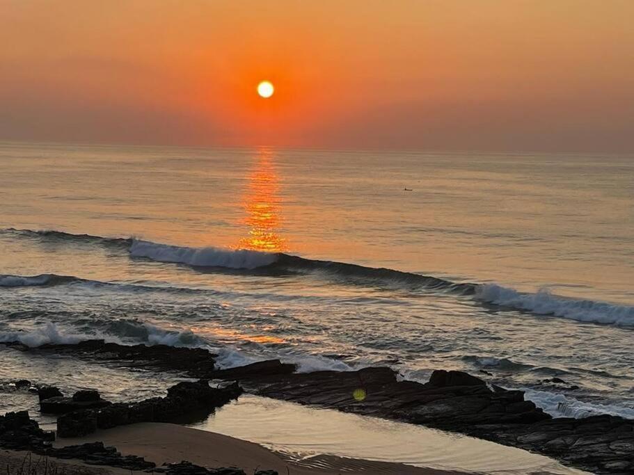Sunset glowing over the ocean at Chaka's Cove