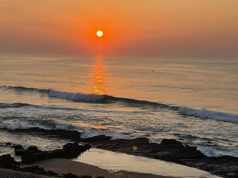 Sunset glowing over the ocean at Chaka's Cove